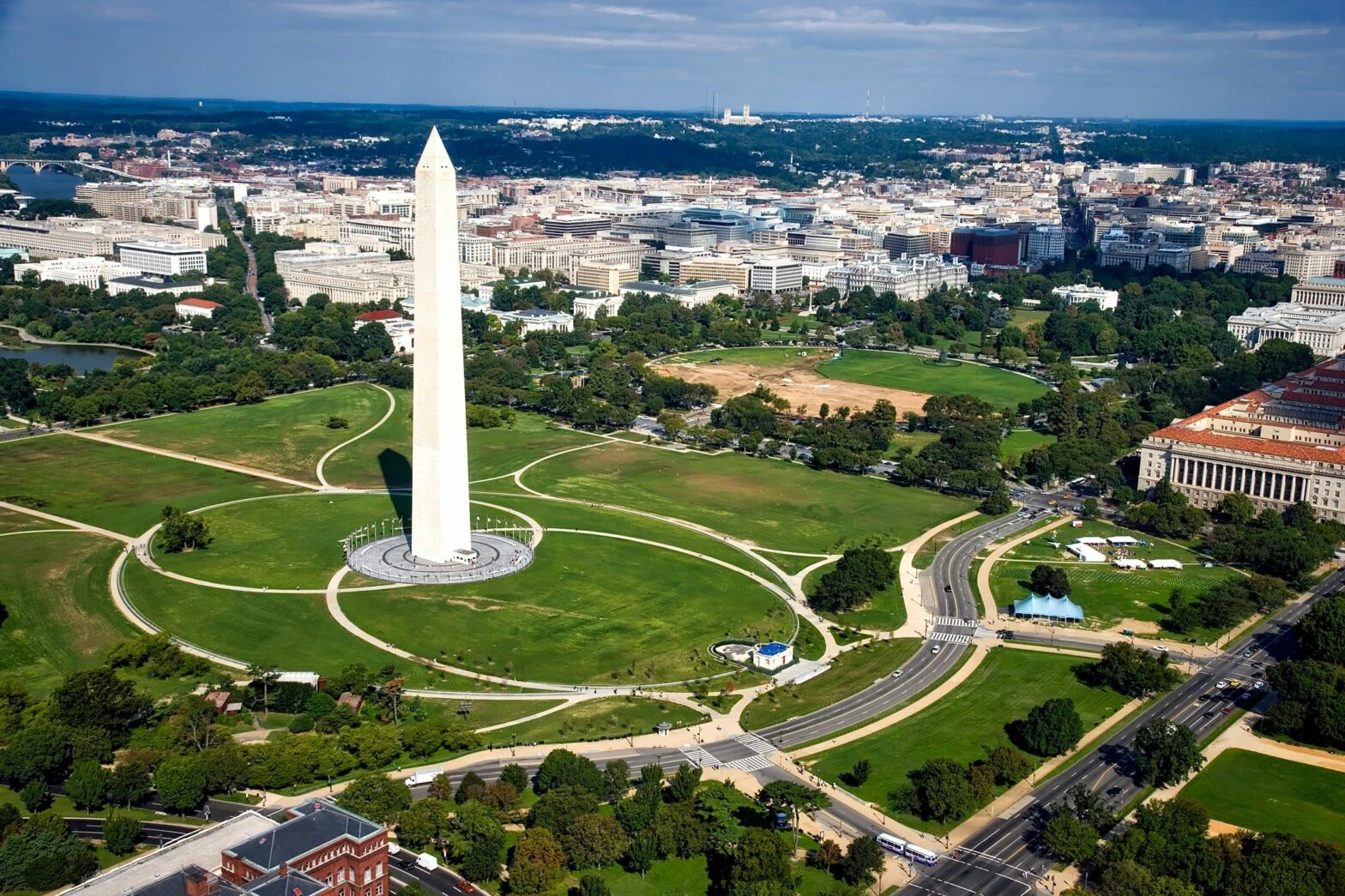 an aerial view of Washington Monument structure and surrounding grassy areas and roads, one of 5 best things to do in D.C.