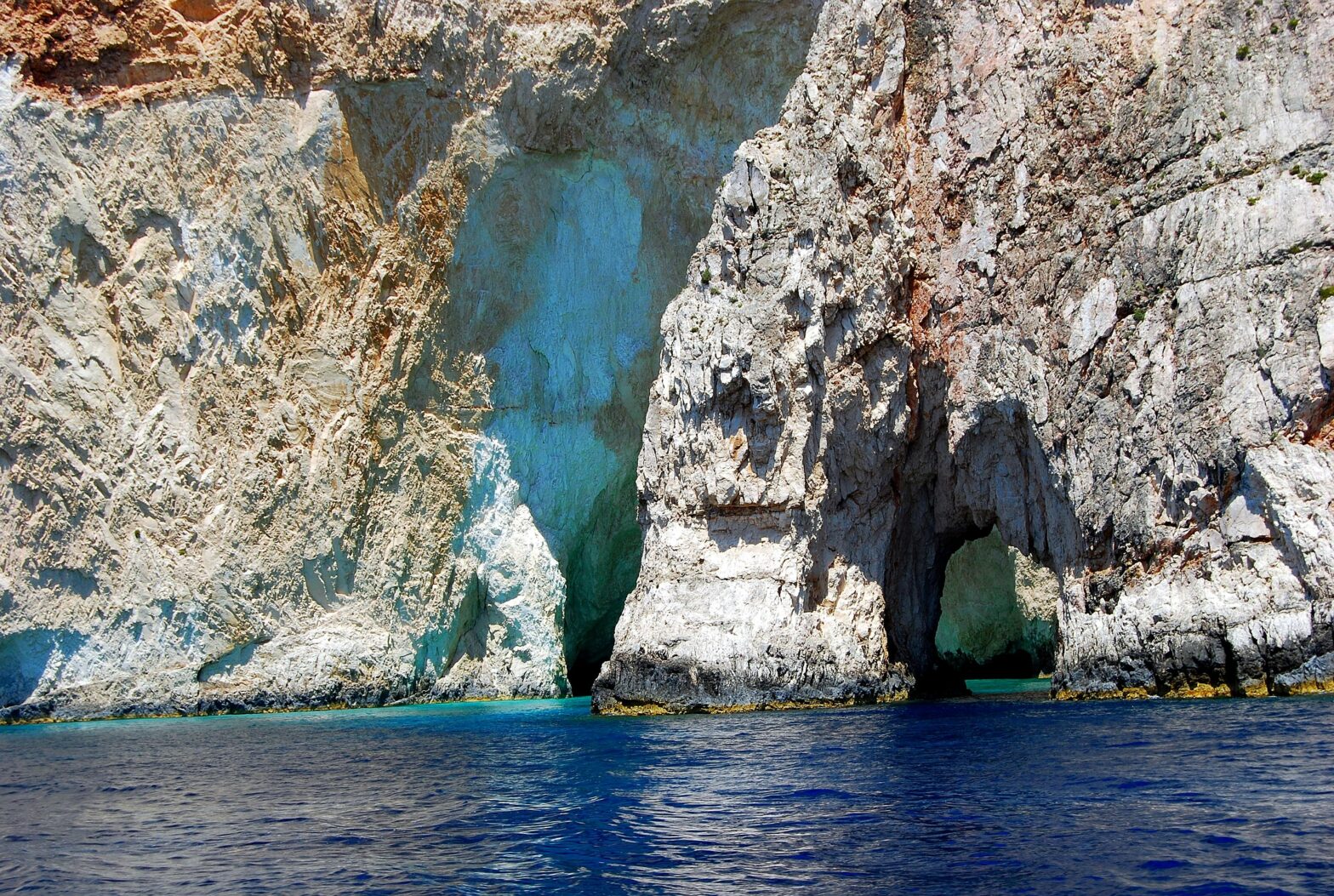 large rock caves in a body of water