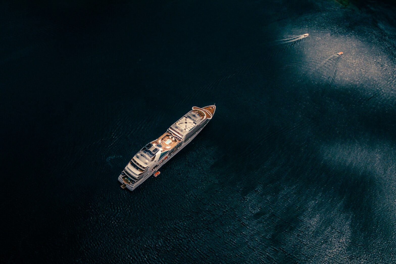 White cruise ship on deep blue waters.