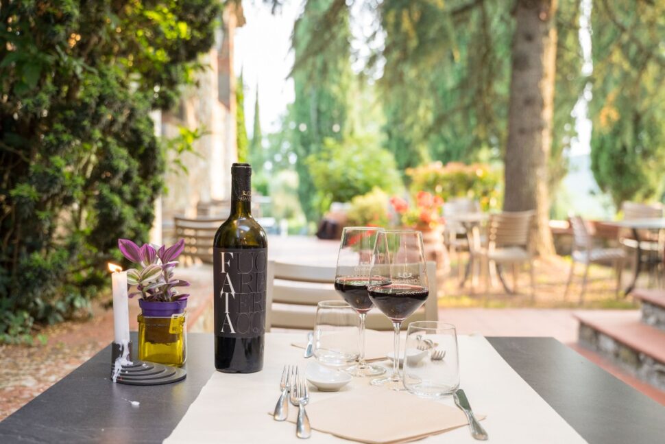 wine bottle and glasses on outdoor patio table