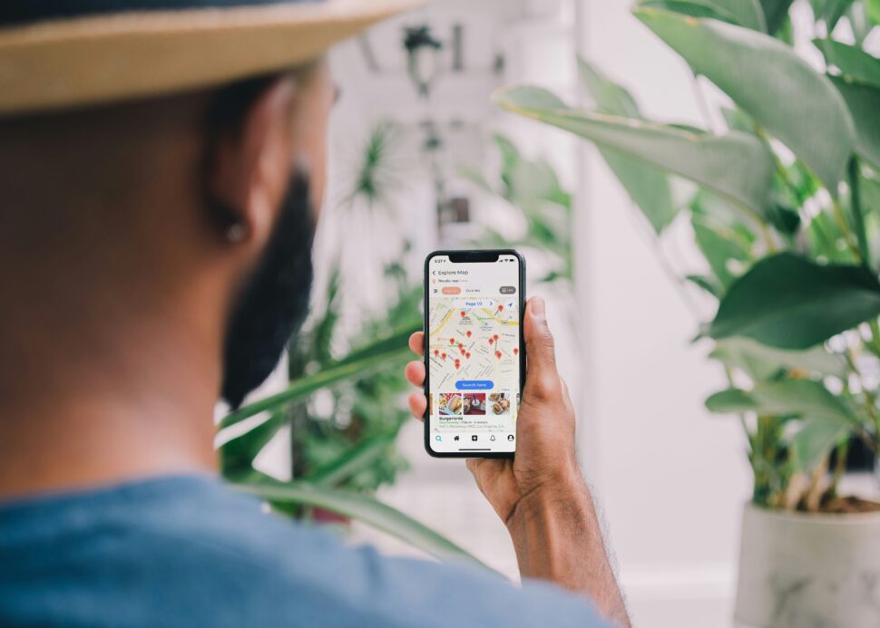 Black man looking at phone map