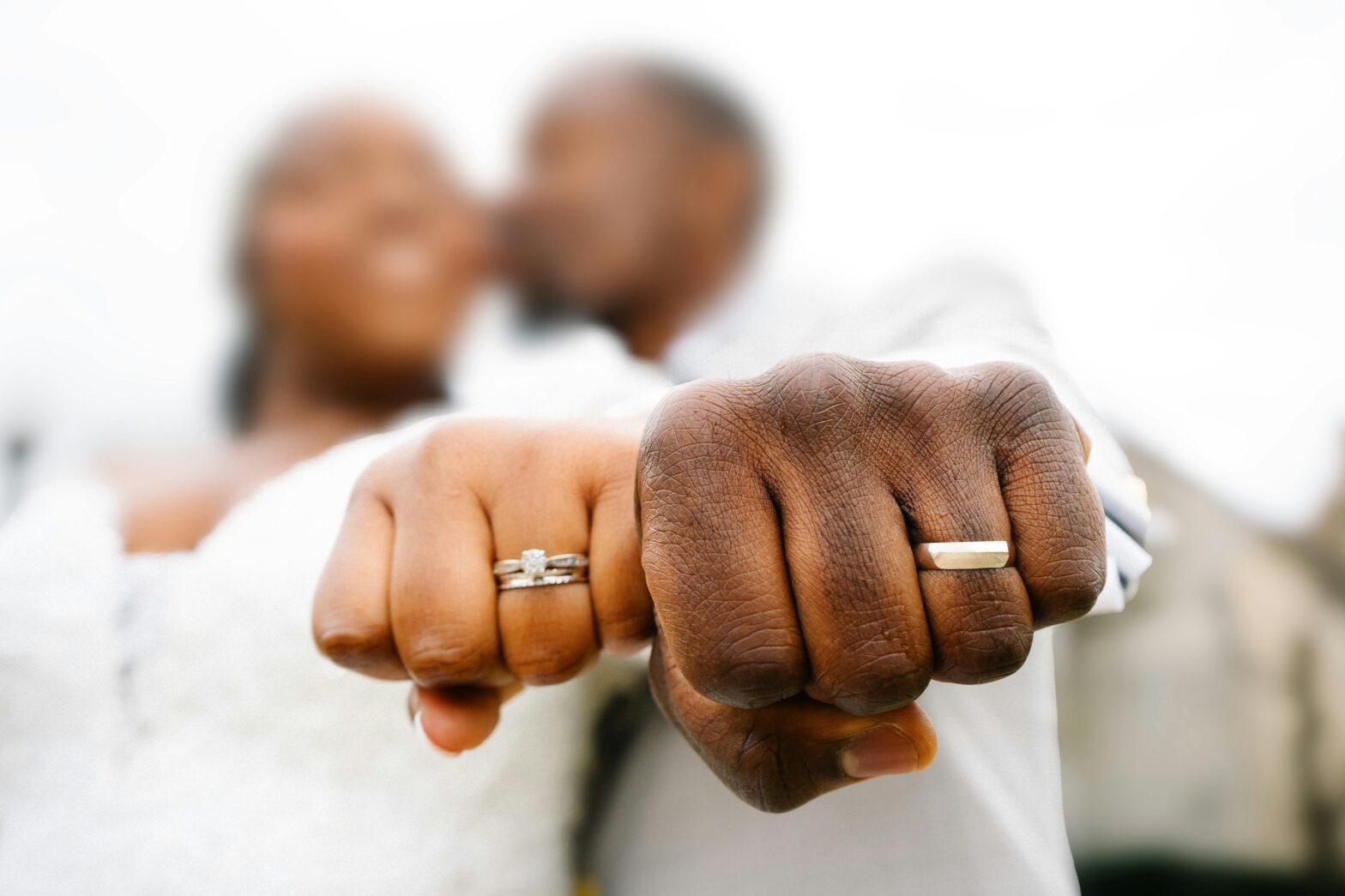 Black couple showing their wedding rings.