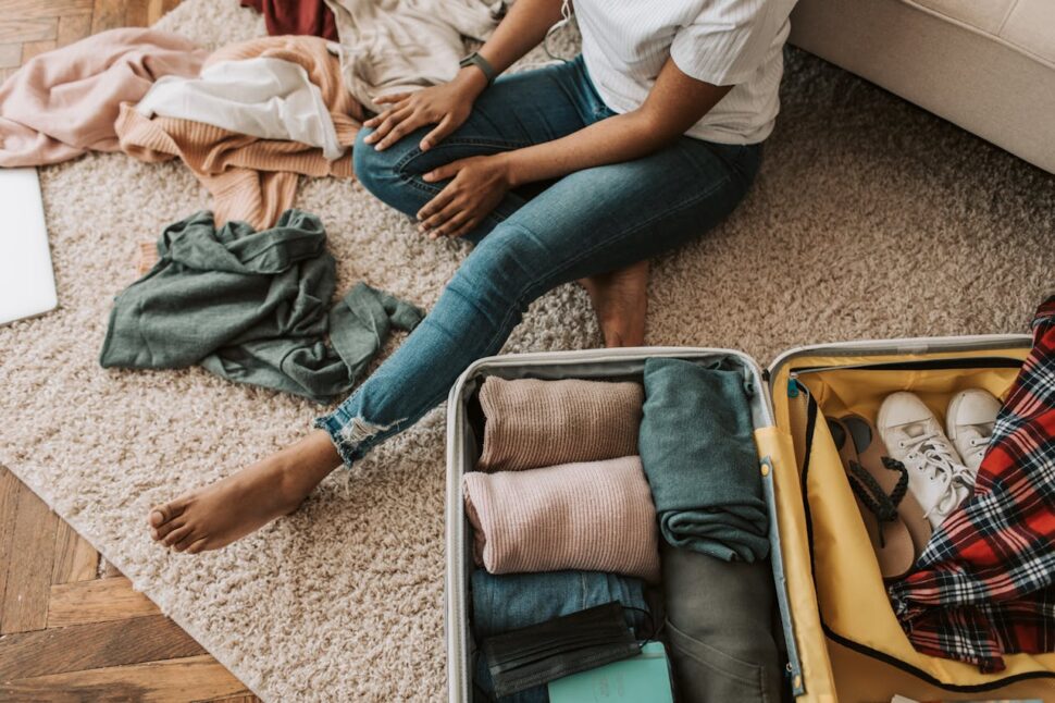 Rolled-up clothes and shoes neatly packed in a suitcase