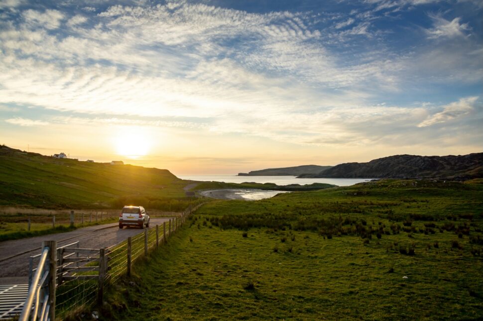 A car driving during sunset in Scotland.