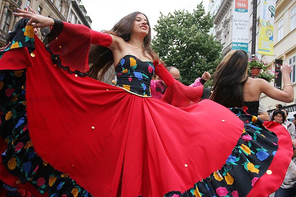 Woman in black and red dress during a street performance at the Khamoro - World Roma Festival in Prague