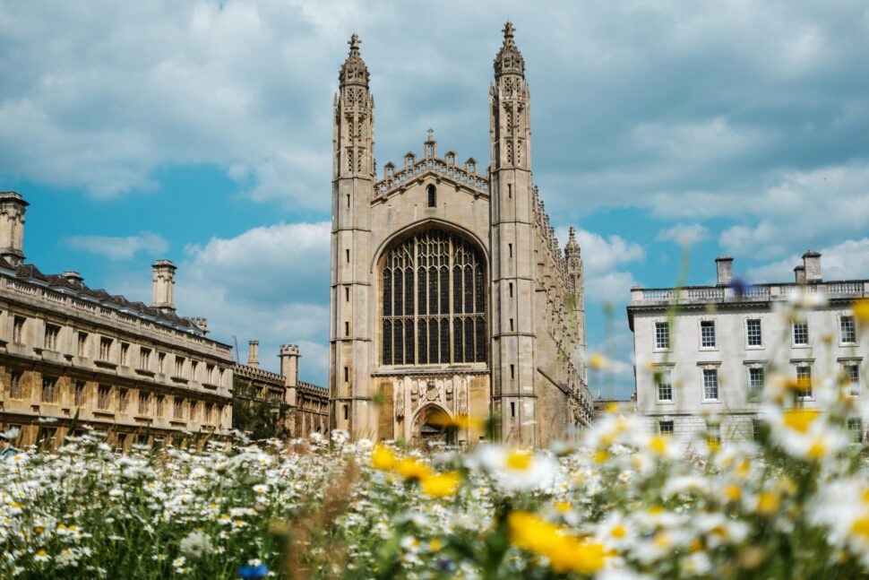 Cambridge University under a cloudy blue sky.