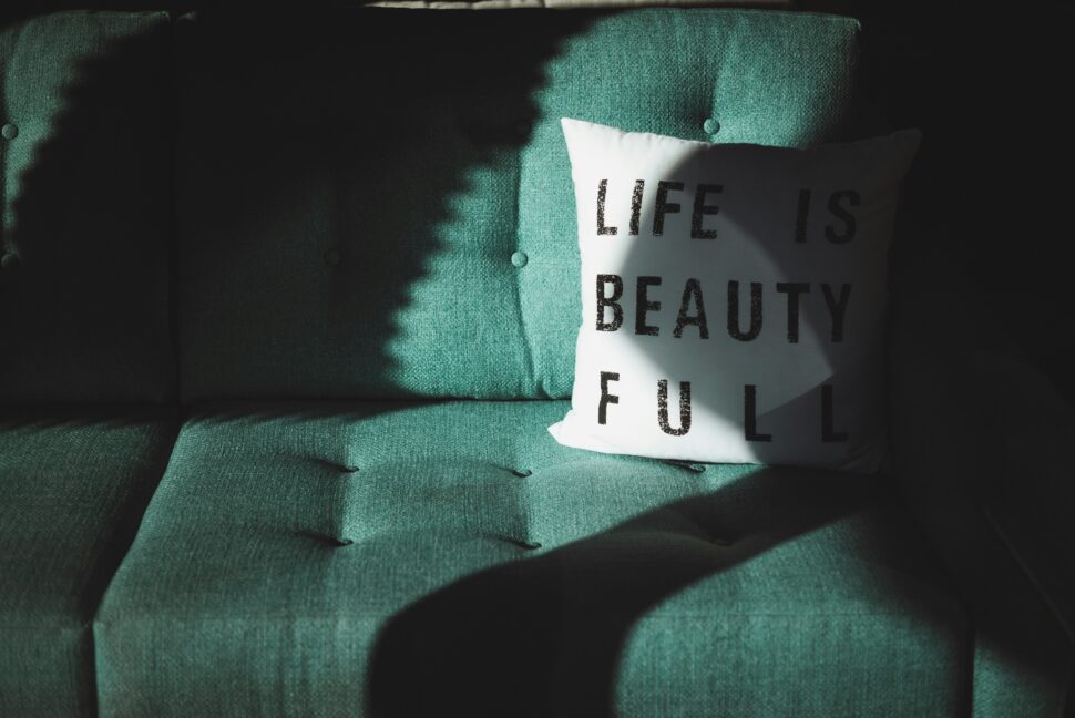 Pillow stating life in beauty full as a play on words.