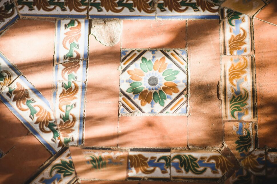 Elaborate stone flooring in Seville, Spain, with intricately decorated floral patterns during the spring season.