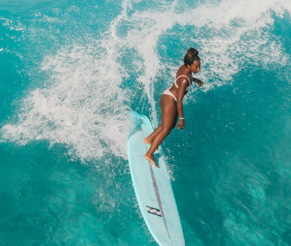 Woman surfs in Oahu waters