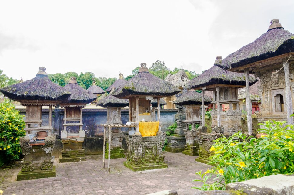 Traditional Balinese shrines surrounded by lush greenery, showcasing the serene cultural beauty of Bali, Indonesia.