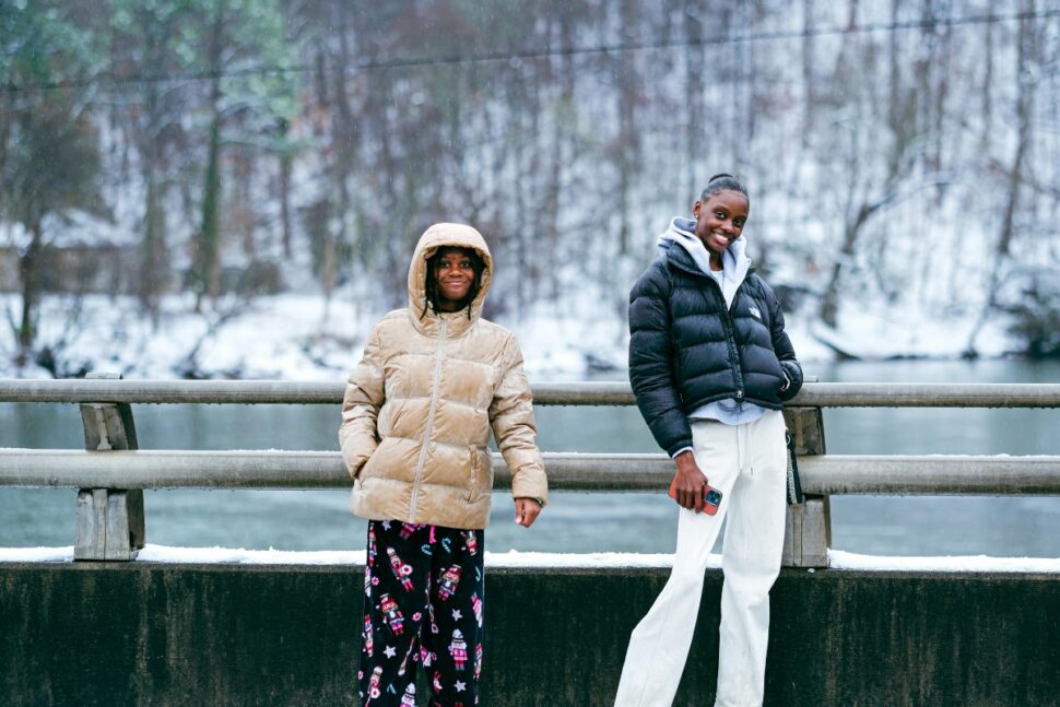 Two Friends Enjoying a Winter Day on a Bridge