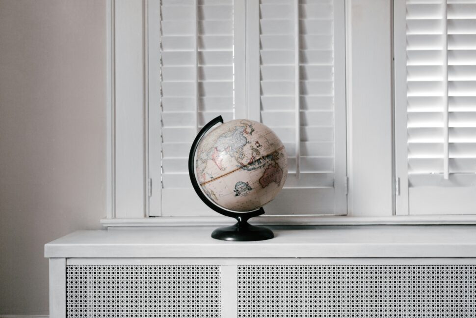 A globe on top of a desk symbolizing travel destinations and rewards programs.