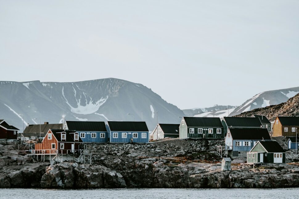 Remote Arctic settlement houses are painted in orange, red and blue in Ittoqqortoormiit, Greenland.