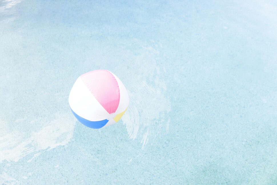 A beach ball on the water in a warm weather destination.