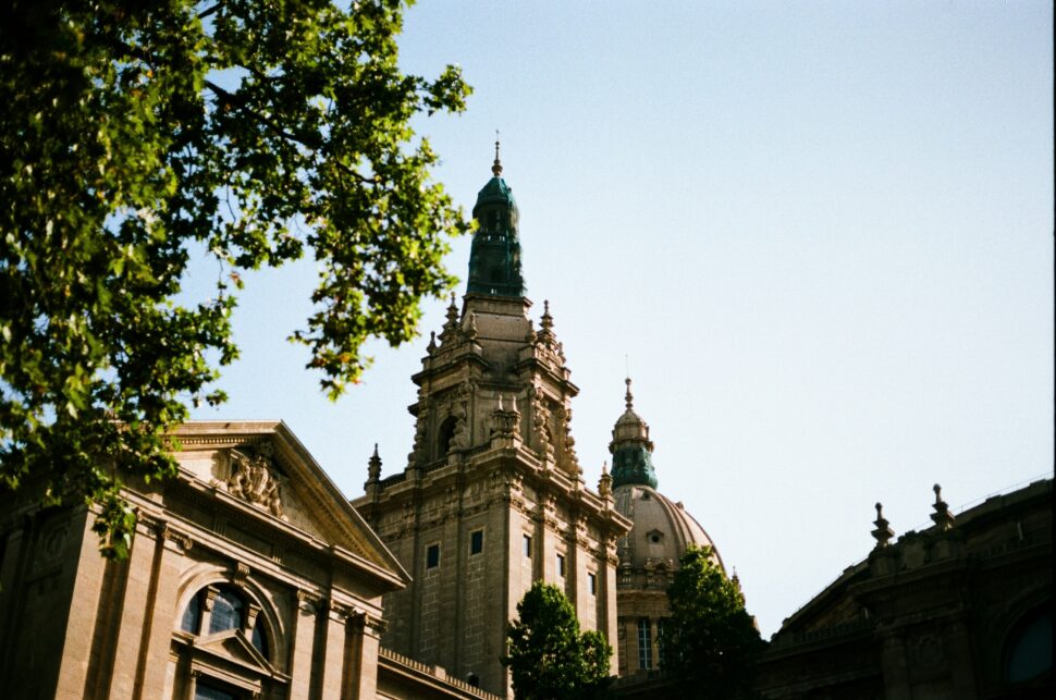 Barcelona spire touching the clear blue sky.