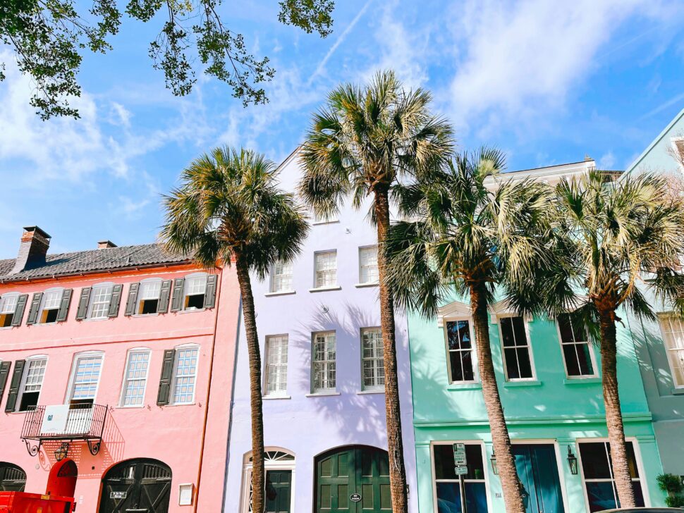 Colorful homes and palm trees in the city of Charleston, South Carolina makes for a warm weather destination.