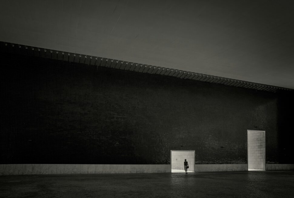 A woman walking from a room for her next trip, using her phone for navigation or safety purposes.