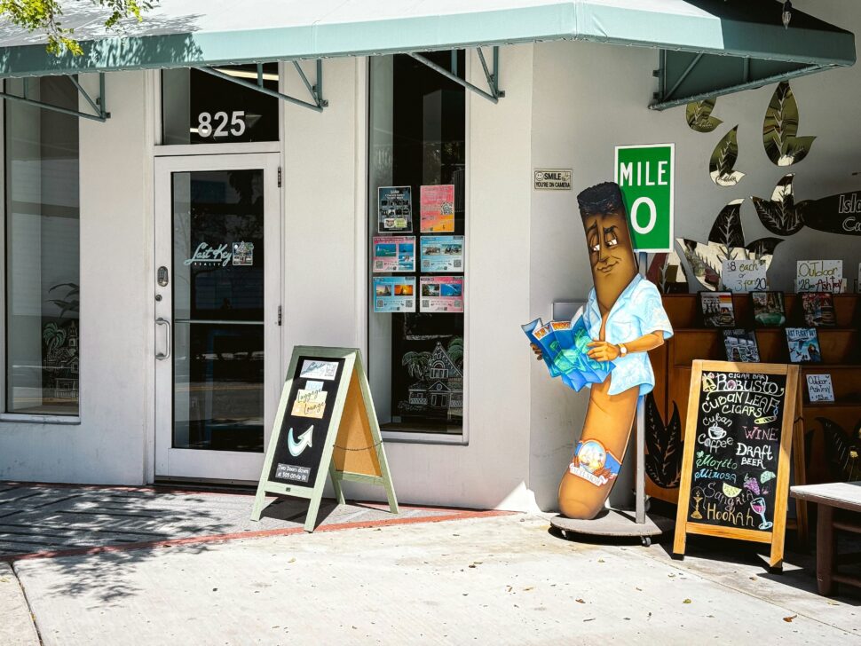 A cigar shop with a banana mascot in Key West, Florida during January is sunny.