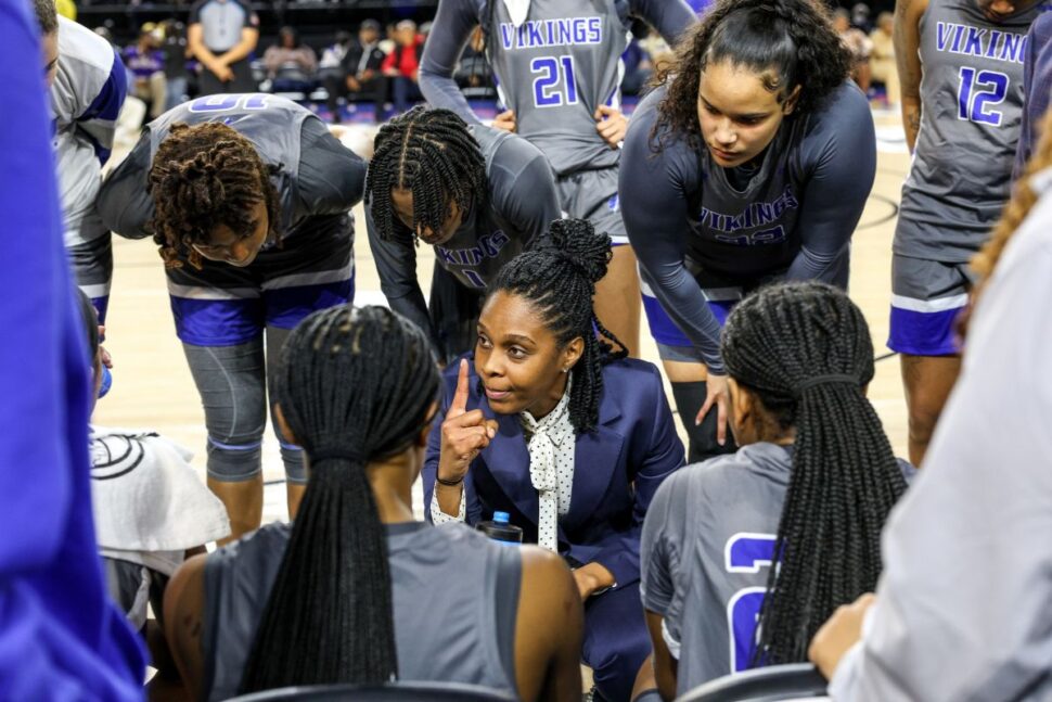 women's coach huddled with her players