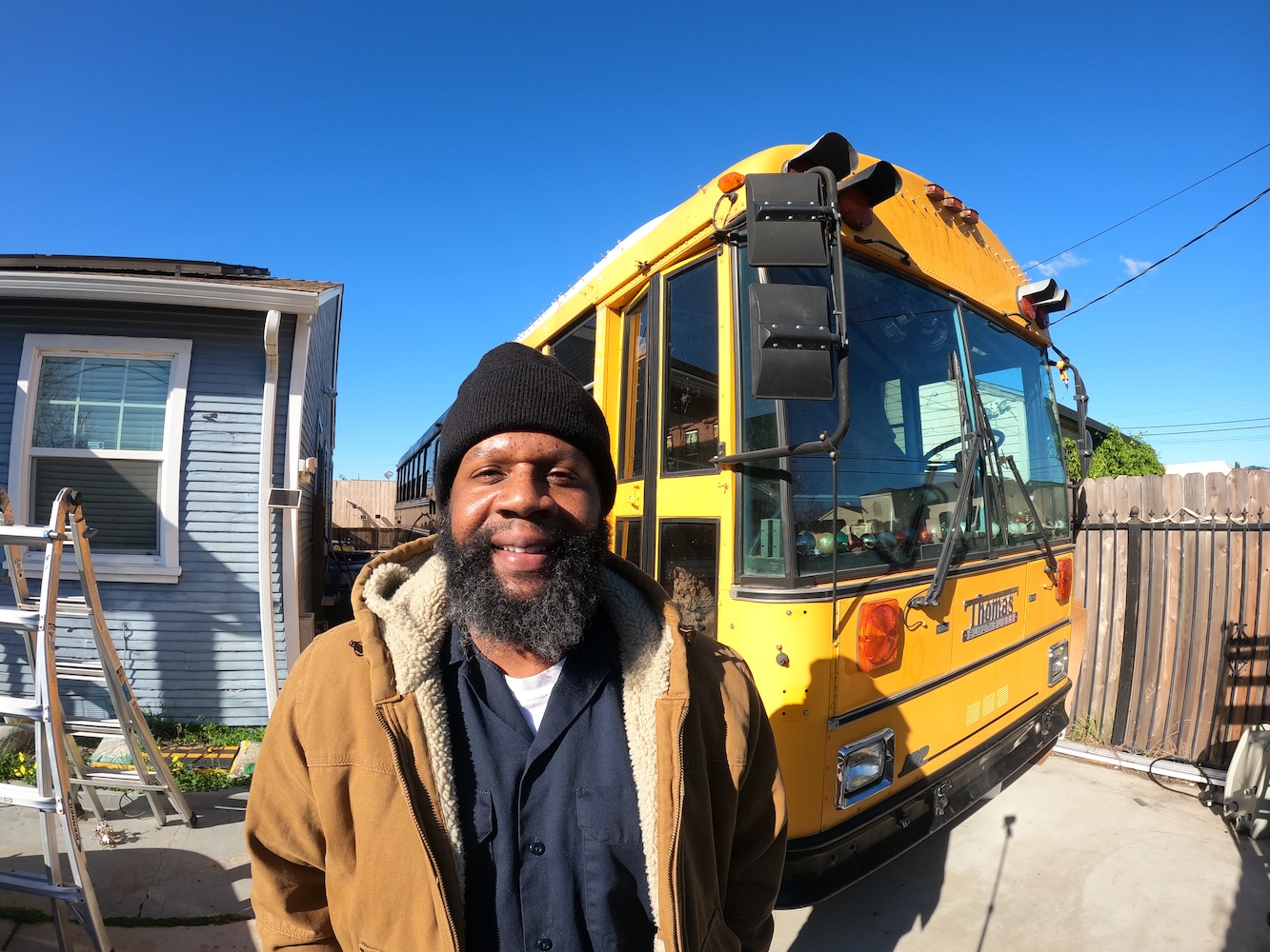 Ansel Troy in front of a school bus he transformed into a tiny home.