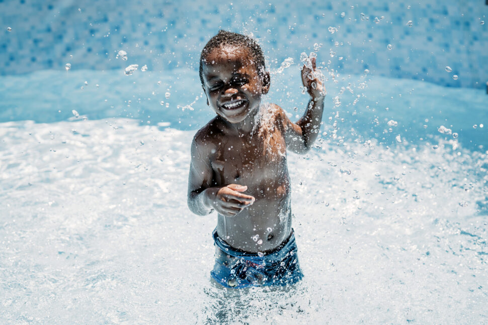 Happy little boy in swimming pool