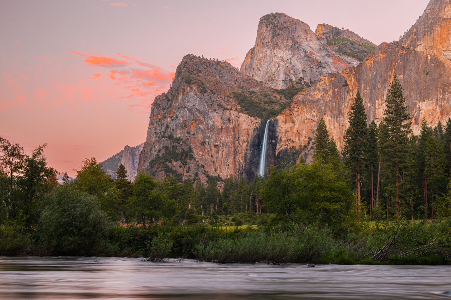 Bridalveill Fall of Yosemite National Park cascades approximately 620 feet (189 meters) from a sheer granite cliff, creating a breathtaking and misty spectacle.