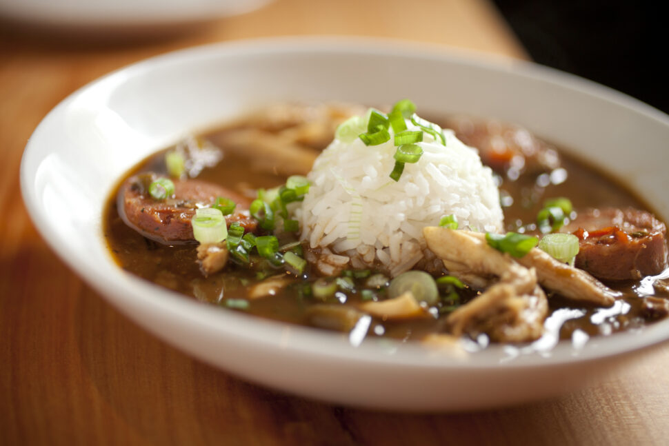 Chicken gumbo with big chunks of chicken and thick slices of andouille sausage, finished off with a scoop of rice in the middle.