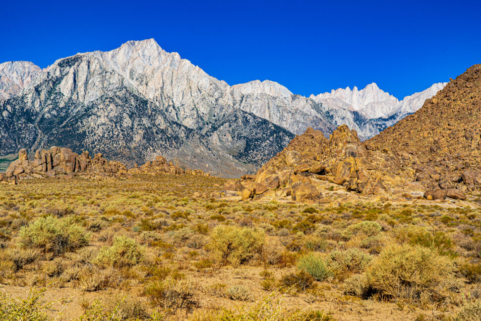 The image shows morning suns lighting up the snow on the peaks above the Alabama Hills and desert east of the Sierra Nevadas in California