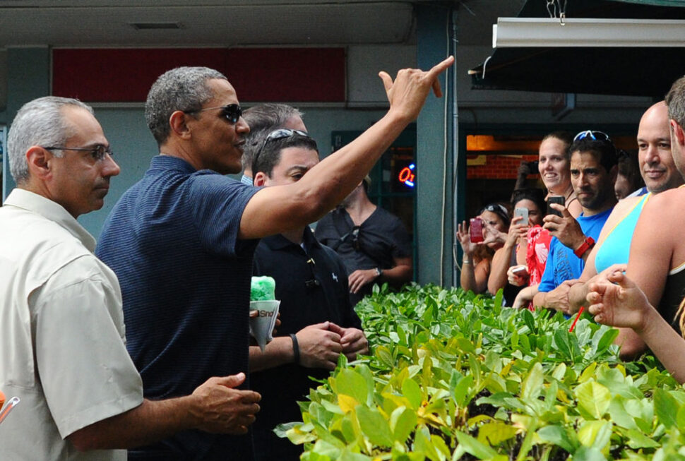 President Barack Obama waves a shaka to a crowd after buying "shave ice" from Island Snow at Kailua Beach Center in Kailua, Hawaii, on December 31, 2013. The First Family is in Hawaii for their annual vacation. 