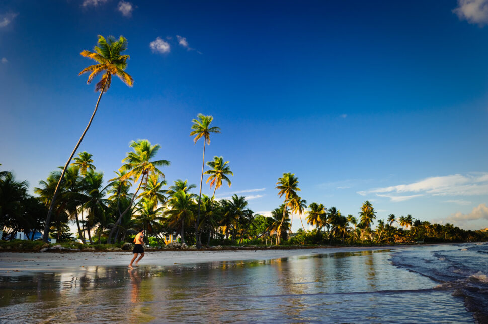 A lone man enjoying a quiet evening while jogging along a secluded beach, Tobago, Trinidad.