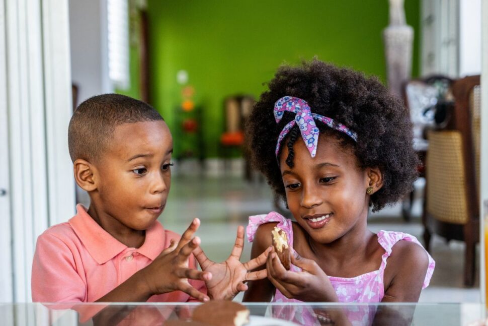 Siblings eating chocolate