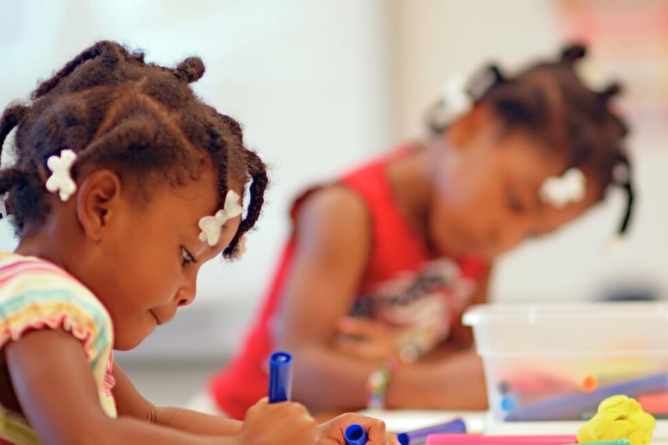 two girls coloring