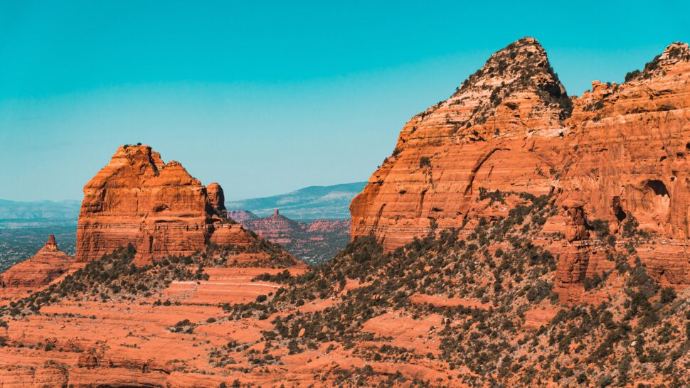 Red rock spires, as if breaking surface.