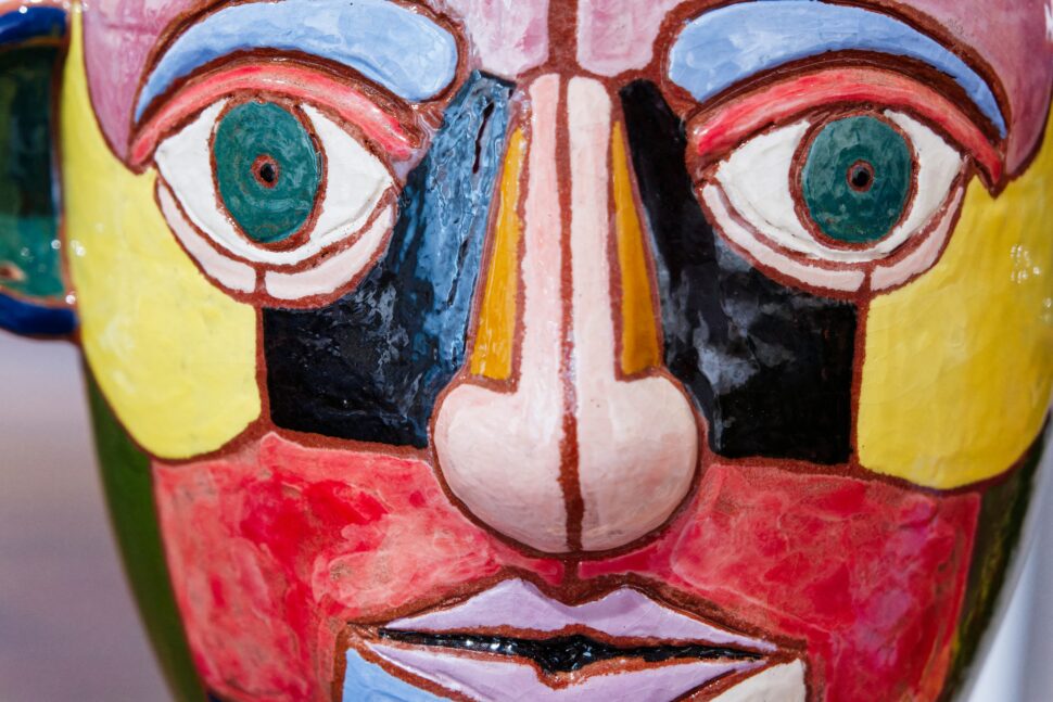 Mask painted in vibrant colors often time on display at indoor museums.