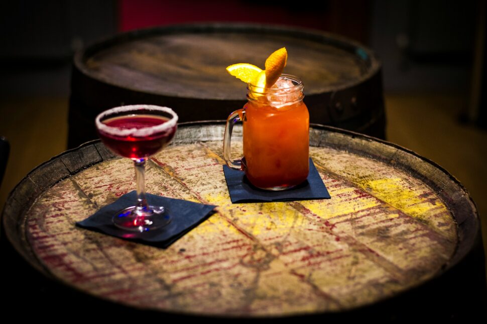 Drinks on a wooden barrel at a speakeasy tucked away from the fickle outdoor weather.