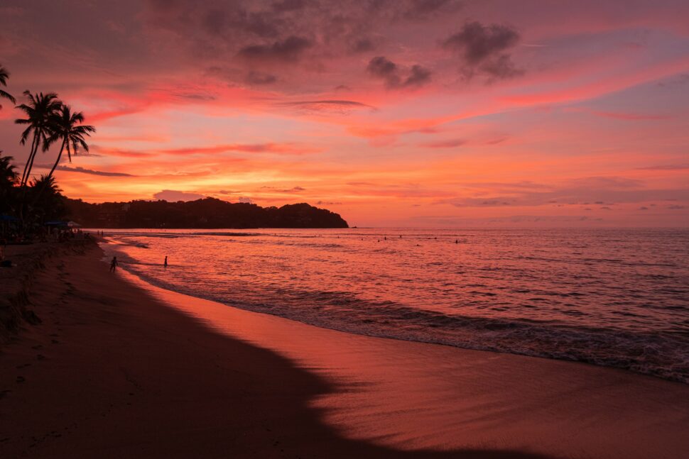 Shoreline doused in red and pink hues for a relaxing getaway in Puerta Vallarta.