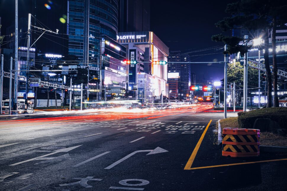 Busan streets lit up for travelers exploring at night.