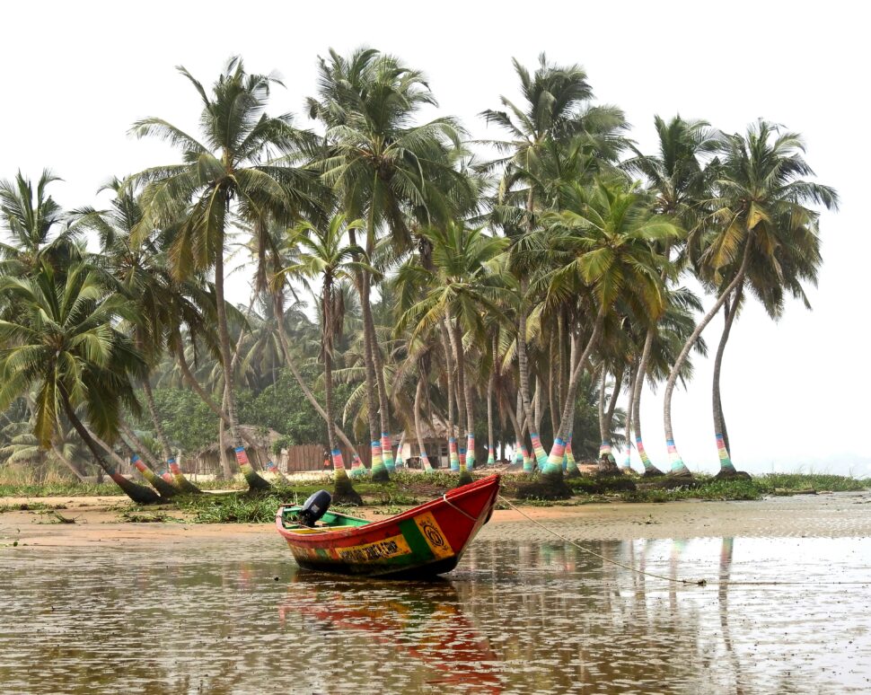 Red boat on beach in Ghana. 