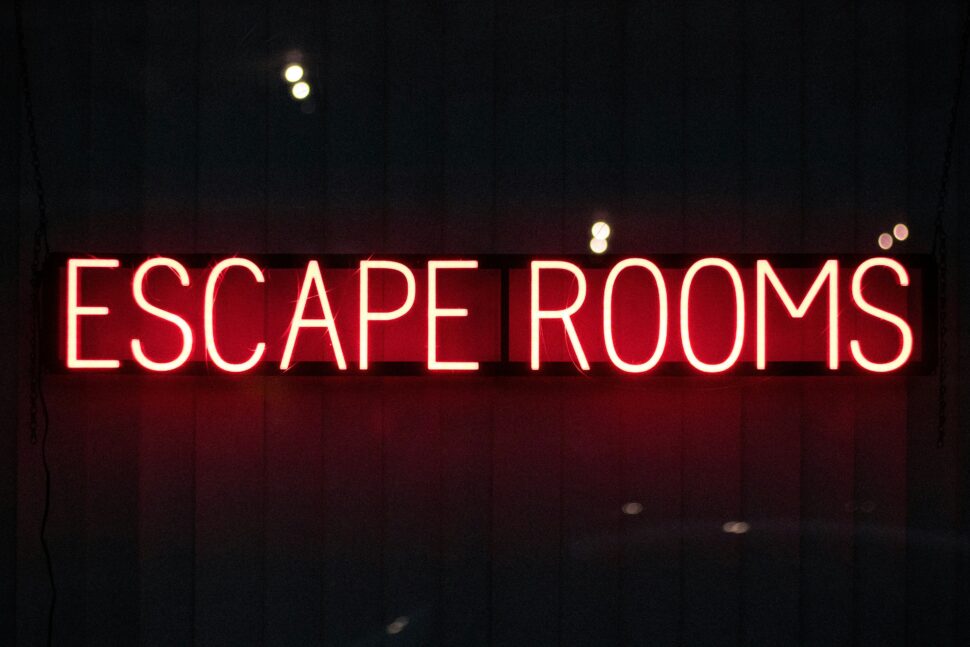 The words Escape Rooms in neon letters for an indoor consideration.