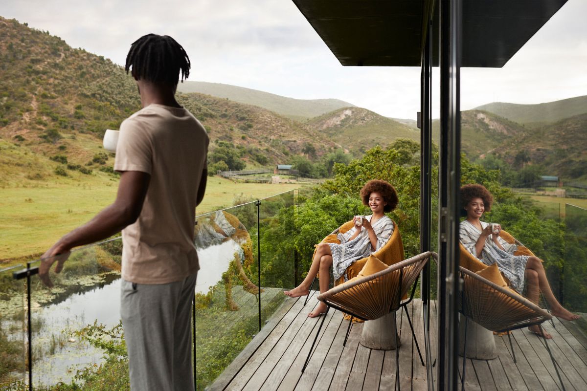 couple smiling at each other on luxury hotel balcony