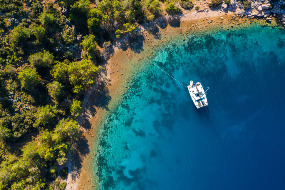 Aerial view of a catamaran yacht in the blue sea. Yachting, luxury vacation at sea. Yachting in the Caribbean