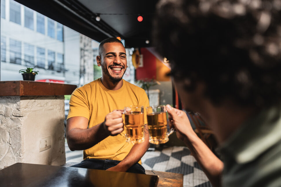 Young man having celebratory toast with friend.