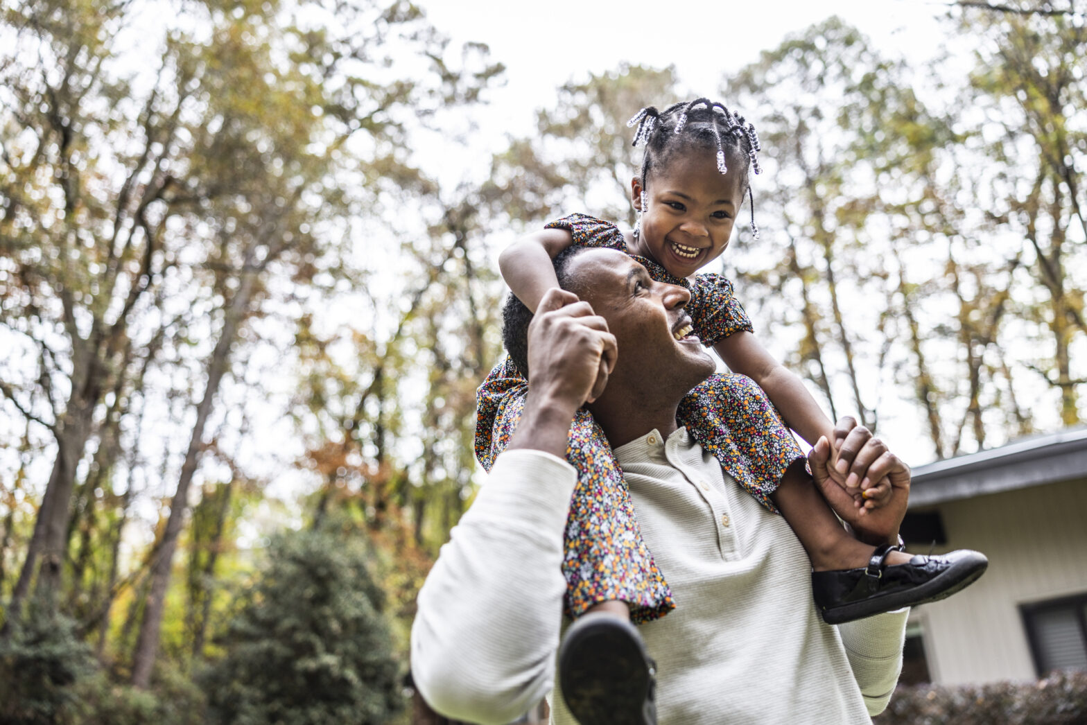 Father giving young daughter a piggyback ride