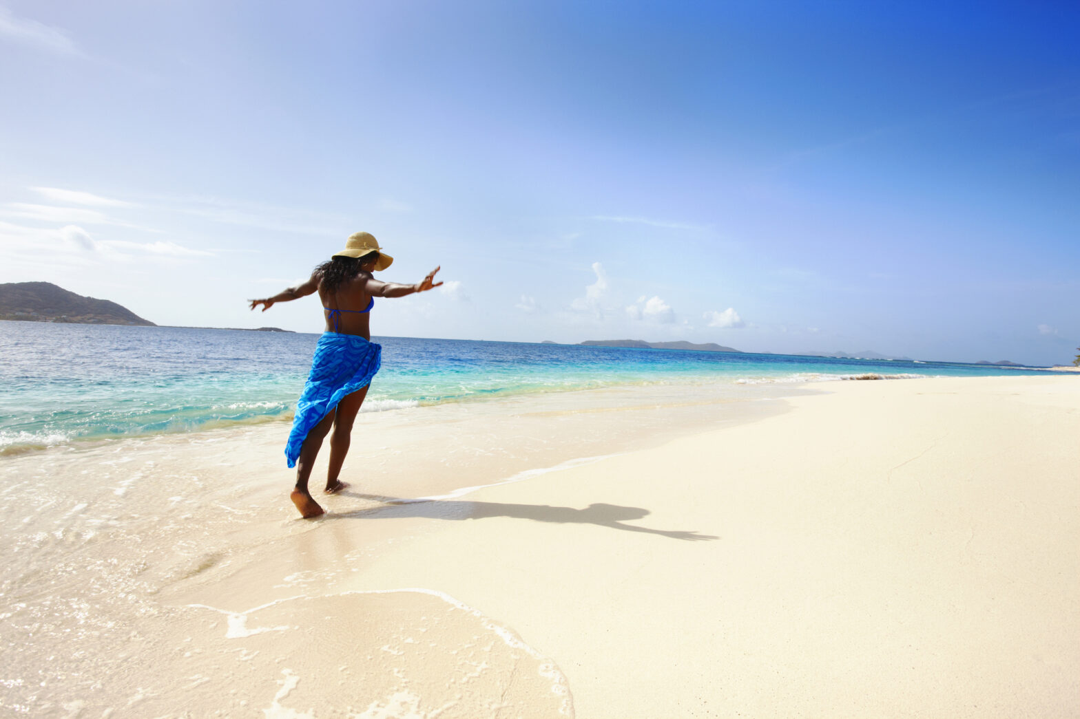 Woman Enjoying a Walk on a Beach