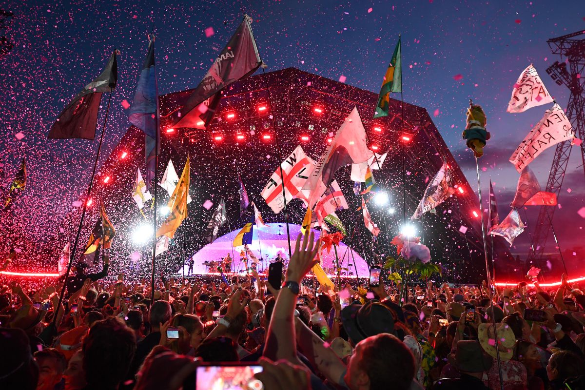 crowd of people at sunset of Glastonbury Festival