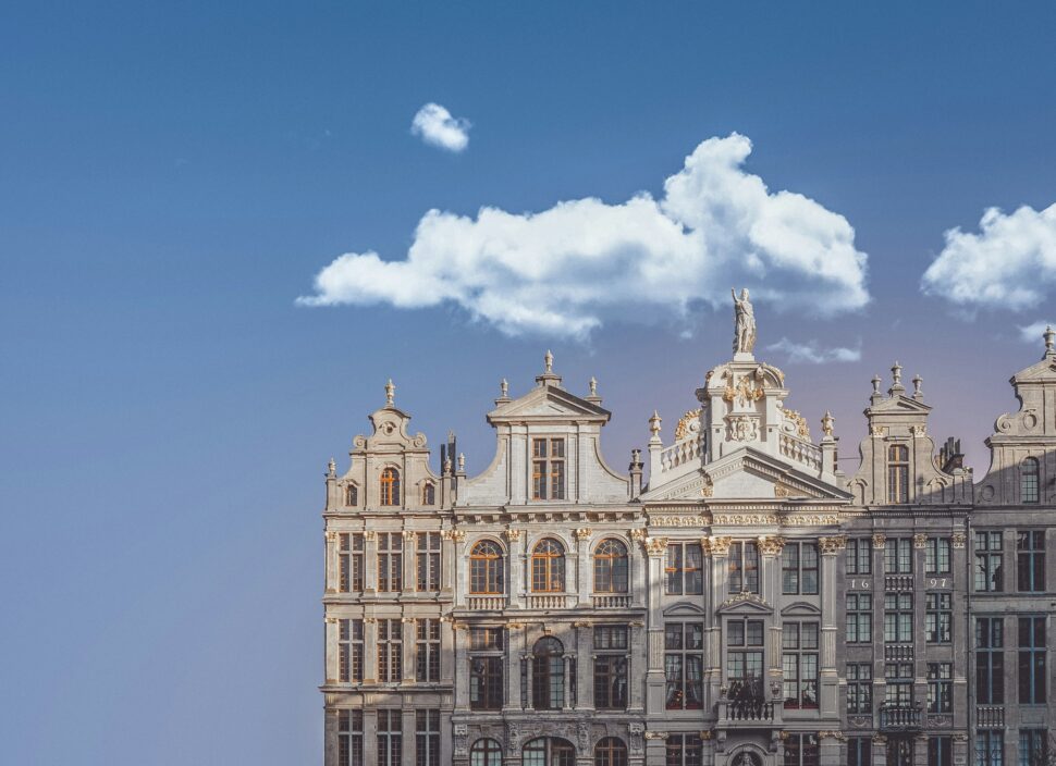 A single dutch building with a cloud lazily passing over