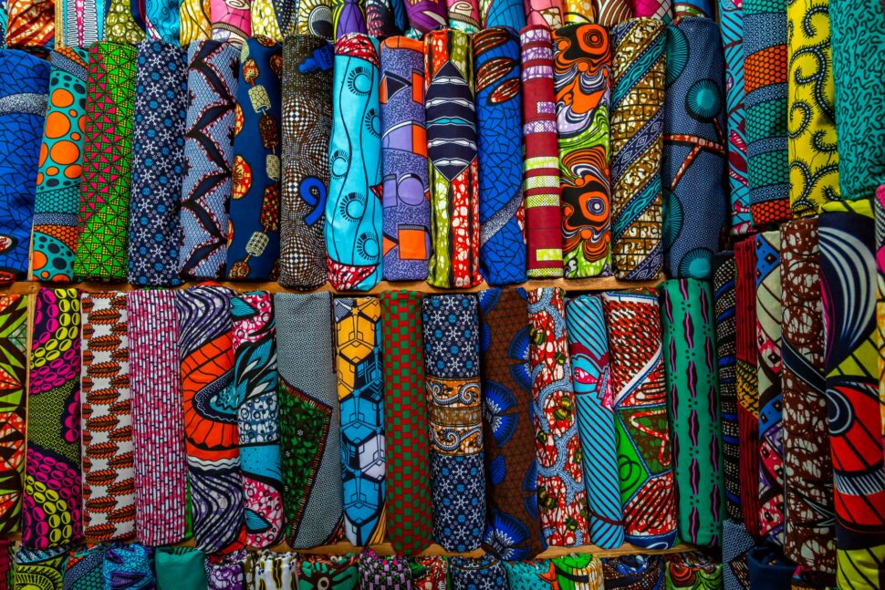 African textiles hanging on racks.