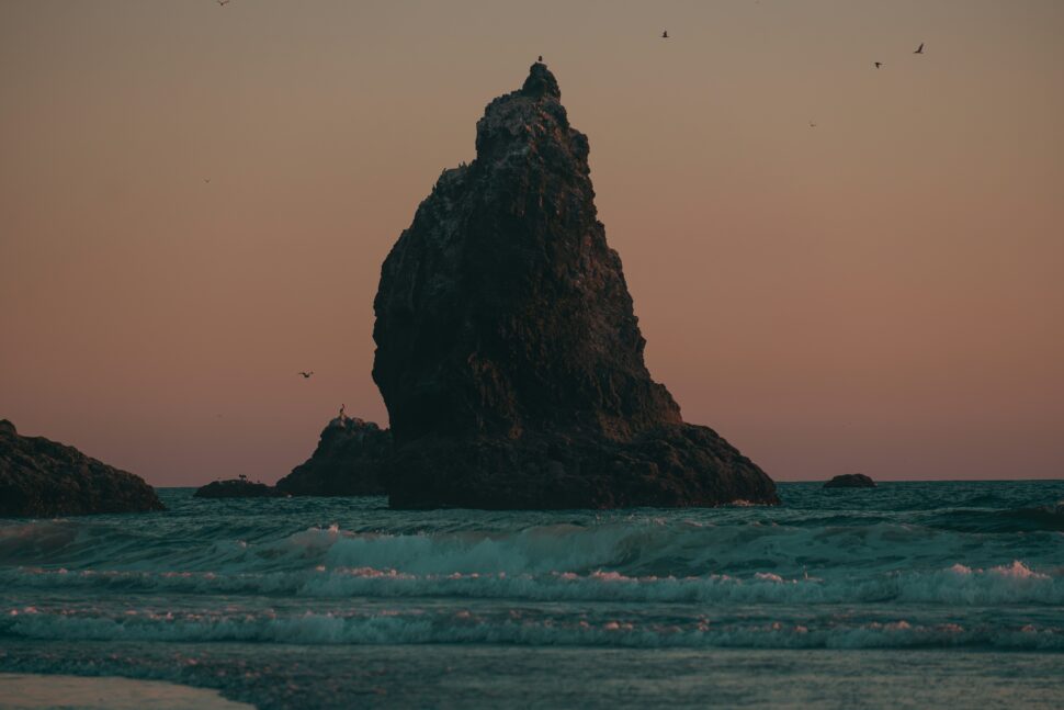 Spire on the beach during sunset.