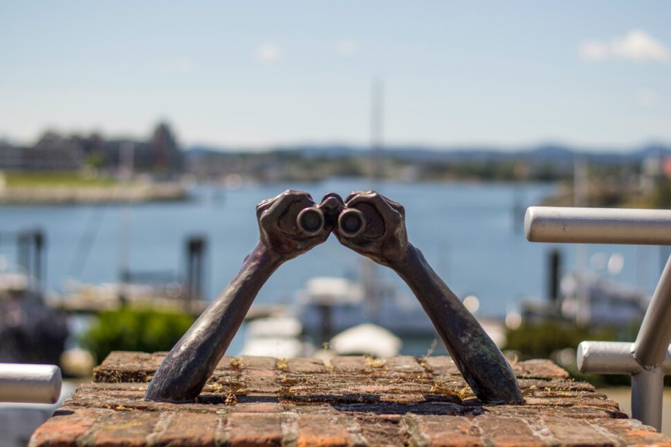 Sculpture of hands holding binoculars for sight seeing on the water