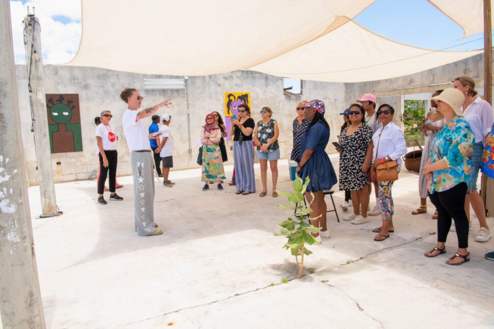 Artist Iain MacRae speaks to visitors about his work during the CAW East bus tour 2024